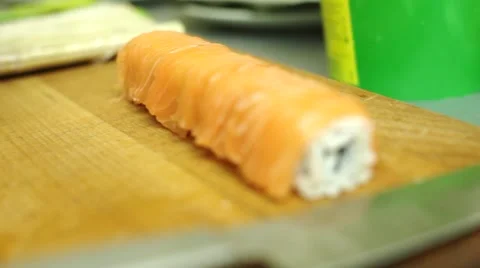 Cooking sushi rolls in the studio. cutting into portions, a round roll of rice Stock Footage 68807893