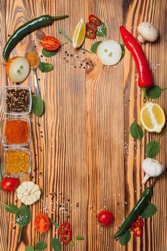 Cooking table. Background with spices and vegetables. Top view. Free space fo Stock Photos