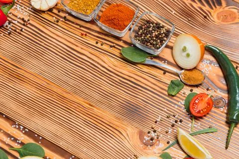 Cooking table. Background with spices and vegetables. Top view. Free space fo Stock Photos