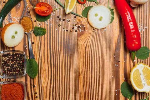 Cooking table. Background with spices and vegetables. Top view. Free space fo Stock Photos