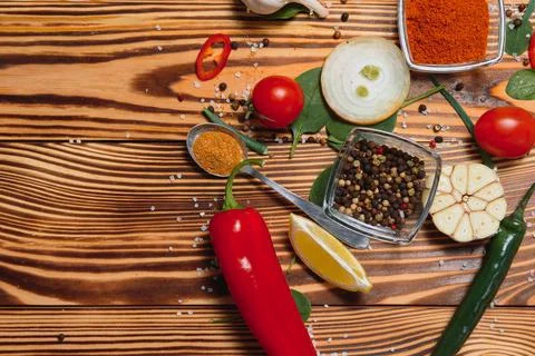 Cooking table. Background with spices and vegetables. Top view. Free space fo Stock Photos