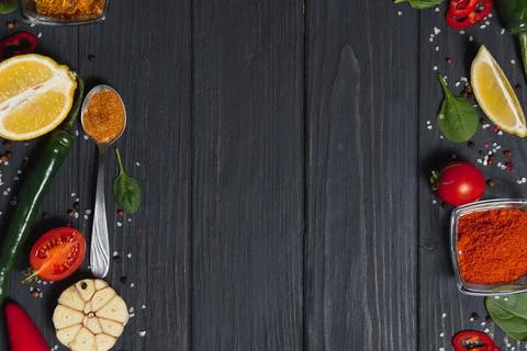 Cooking table. Background with spices and vegetables. Top view. Free space fo Stock Photos