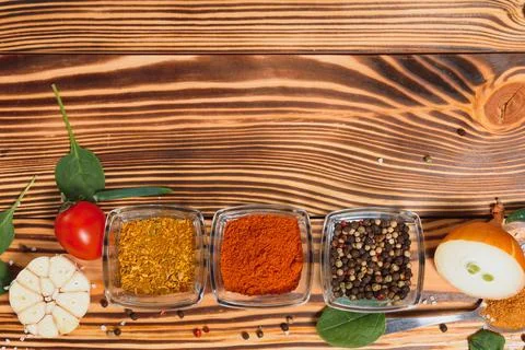Cooking table. Background with spices and vegetables. Top view. Free space fo Stock Photos
