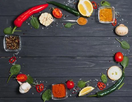 Cooking table. Background with spices and vegetables. Top view. Free space fo Stock Photos