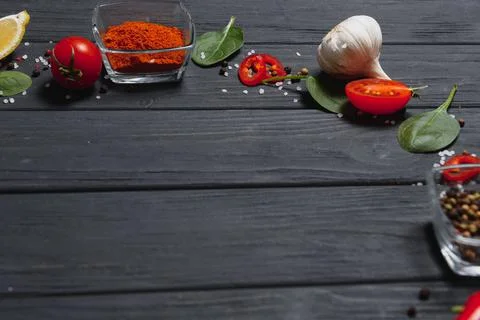 Cooking table. Background with spices and vegetables. Top view. Free space fo Stock Photos
