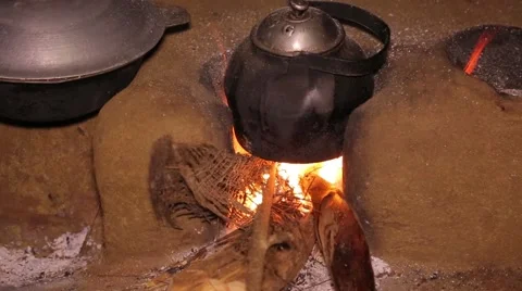 Cooking in a teapot at a small fire pit in Sri Lanka Stock Footage 49364851