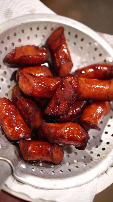 Cooking Thai food: deep fried Chinese sweet pork sausages sliced and cooked in h Stock-Footage 341499448