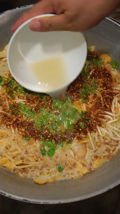 Cooking Thai food: preparing simple spicy tom yum noodle soup with minced pork a Stock-Footage 341859618