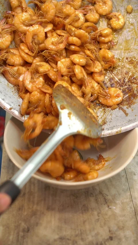 Cooking Thai food: stir-frying fresh prawns with minced garlic and palm sugar in Stock Footage 342003174