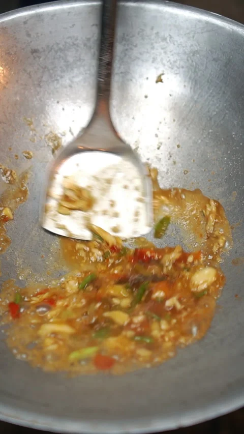 Cooking Thai stir-fried crispy pork belly with holy basil and chili. Stock Footage 336629944