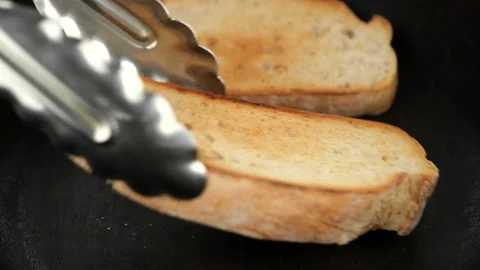 Cooking toasts sliced bread in a frying pan Stock Footage 200165737