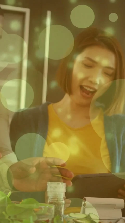 Cooking together in kitchen, couple using tablet with green bubbles animation Stock Footage 343824518