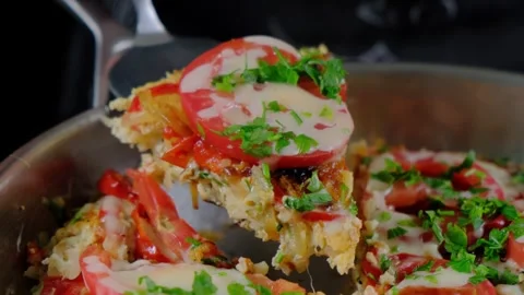Cooking a Tomato and Herb Topped Dish in a Frying Pan Stockbeeldmateriaal 341431663