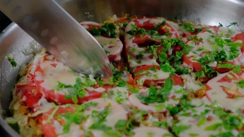 Cooking tomatoes and cheese in a pan with herbs Video stock 341446607