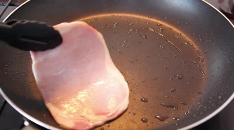 Cooking two bacon rashers in a frying pan Stock Footage 36147509