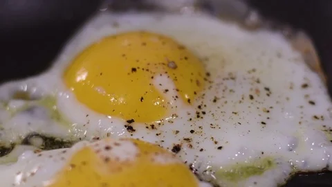 Cooking two eggs over a residential kitchen stove 스톡 동영상 82584068