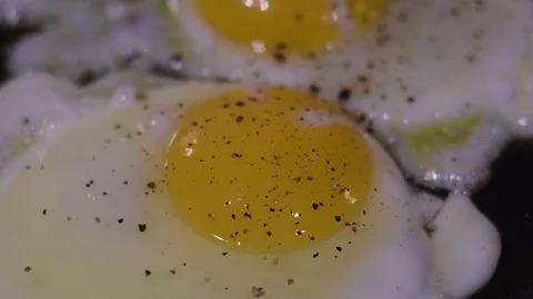 Cooking two eggs over a residential kitchen stove Video stock 82585087