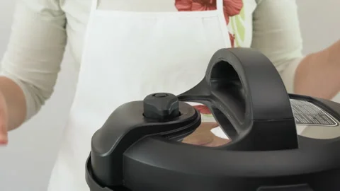 Cooking using modern electric multi cooker, pushing the valve to the venting pos Stock Footage 131237690