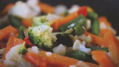 Cooking vegetable, close up of mixture of carrots, broccoli, cabbage in a pan.  Stock Footage 144260108