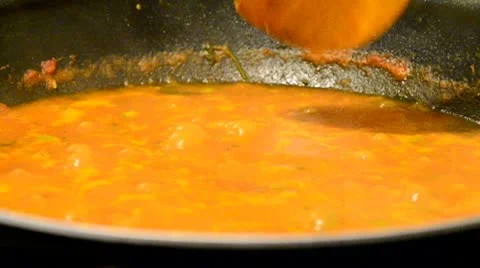 Cooking vegetable curry being stired with wooden spoon Stock Footage