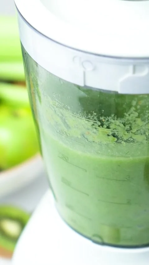 Cooking vegetable fruit smoothie in blender, vertical slow motion of the process Stock Footage 273732093