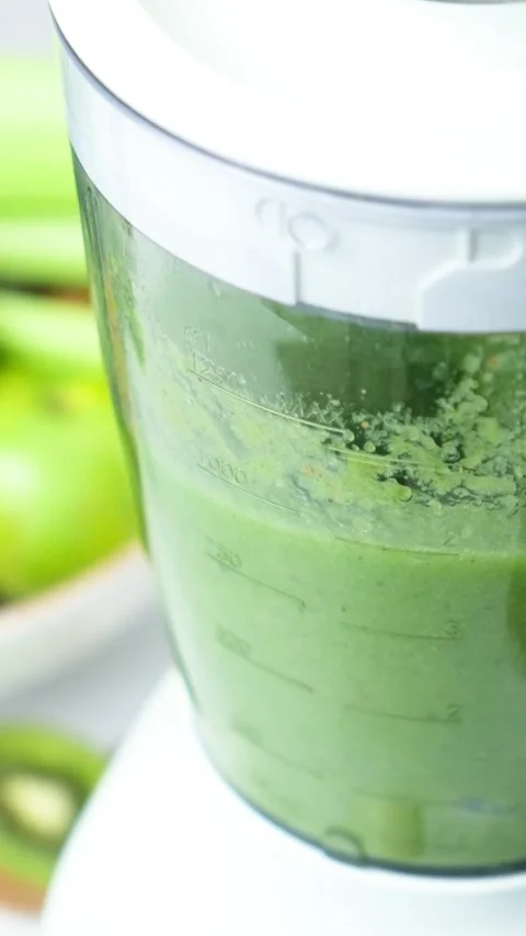 Cooking vegetable fruit smoothie in blender, vertical slow motion of the process Stock Footage 274531489