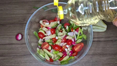 Cooking Vegetable Salad. Adding Oil Into Salad Stock Footage 165505378