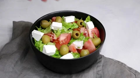 Cooking vegetable salad. The cook puts the green olive in the salad. Stock Footage 157492952