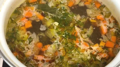 Cooking vegetable soup in a pan on the gas stove Stock Footage 224720102