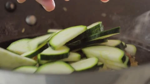 Cooking vegetable, zucchini slices falling down in a pan. Food footage Stock Footage 170081444