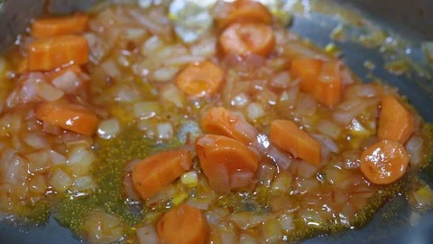 Cooking vegetables for a dish of vegetables with seafood in an iron pan Stock Footage 107181772