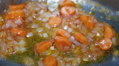 Cooking vegetables for a dish of vegetables with seafood in an iron pan Stock Footage 107181799
