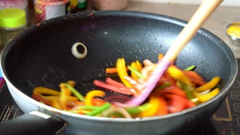 Cooking Vegetables on frying pan. Mixed vegetables frying into the pan. 動画素材 149506607