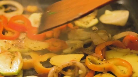 Cooking vegetables in a grilled pan close up slow motion Stock Footage 99828822