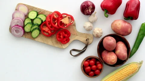 Cooking vegetables on a kitchen table. Hands cutting red pepper Stock Footage 131568916