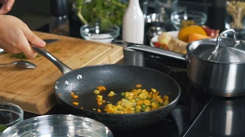 Cooking vegetables, in pan brew corn, peas, onions and carrots, pepper side dish Stock Footage 123465061