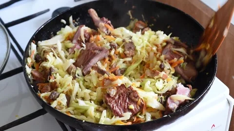 Cooking vegetables in a pan cabbage with meat Stock Footage 63156659