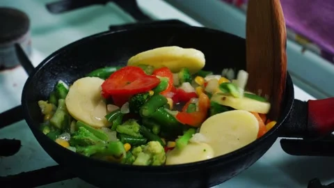 Cooking vegetables in a pan Stock Footage 197375555