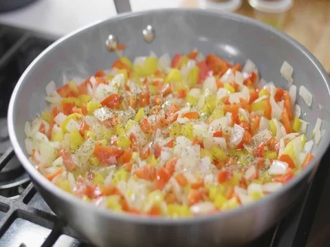 Cooking vegetables in a pan in slow motion Stock Footage 80544751