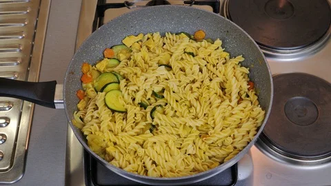 Cooking vegetables with pasta in wok Video stock 87304380