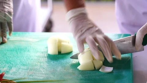 Cooking video close up The chef's hand is slicing herbal vegetables to prepar Stock Footage 120165198