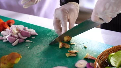 Cooking video close up The chef's hand is slicing herbal vegetables to prepar Stock Footage 120165418