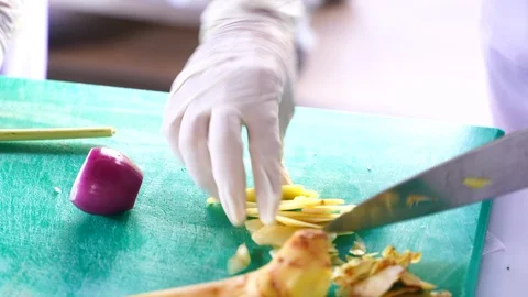 Cooking video close up The chef's hand is slicing herbal vegetables to prepar Stock Footage 120165535