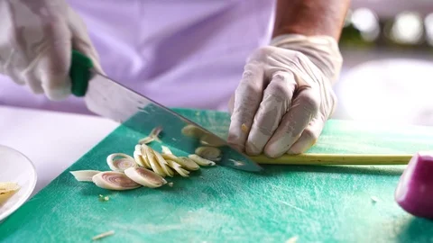 Cooking video close up The chef's hand is slicing herbal vegetables to prepar Stock Footage 120165644