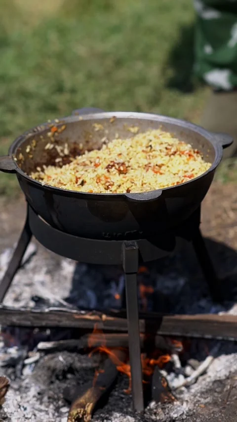 Cooking while camping outdoors Stock Footage 314235313