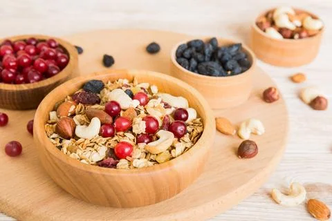 Cooking a wholesome breakfast. Granola with Various dried fruits and nuts in  Stock Photos