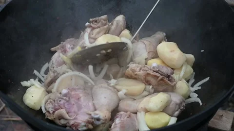 Cooking in winter in a cauldron in the open air on a fire. food from potatoes Stock Footage 142458507