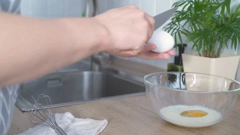 Cooking, women's hands break an egg with a knife,cooking omelets, scrambled eggs Stock Footage 126909447