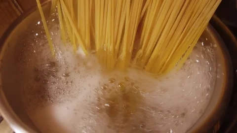 Cooking Yellow Spaghetti in Boiling Water Stock Footage 344669727