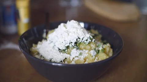 Cooking zucchini pancakes. Breaking the egg and mixing with pancake's ingredient 動画素材 104101022